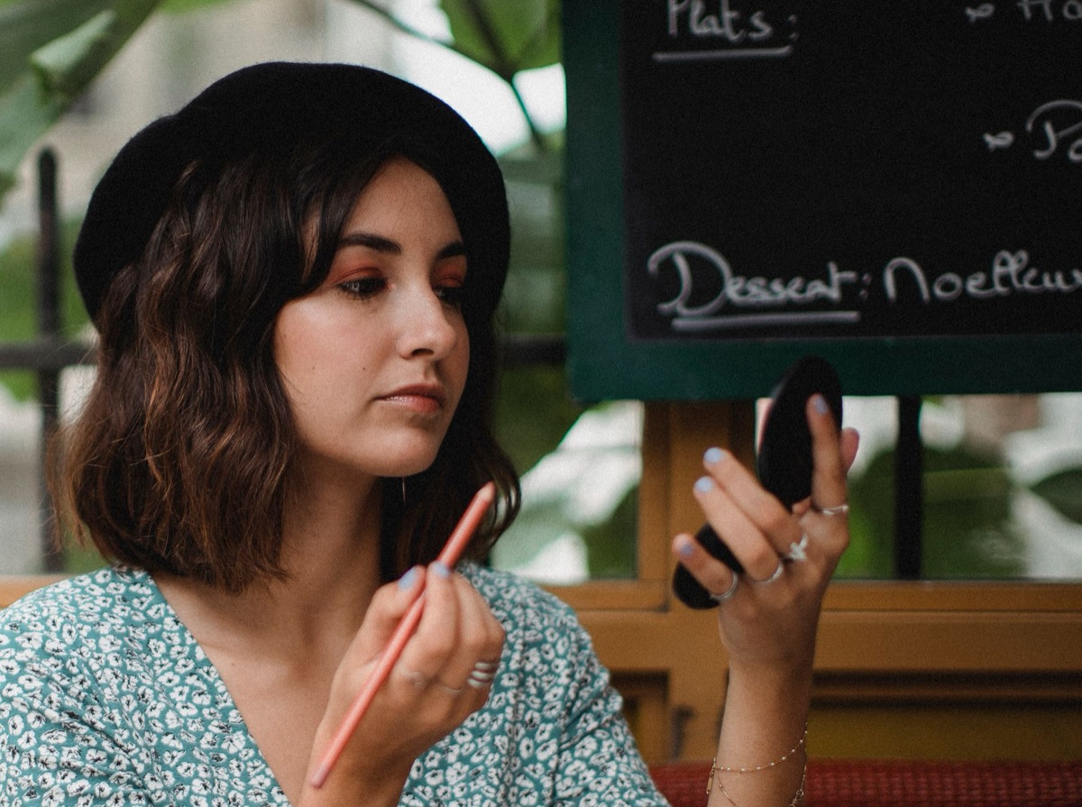 Close-up of classic French red lipstick and natural makeup aesthetic